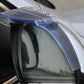 Transparent rain guard attached to a car side mirror, flexible fit over the edge