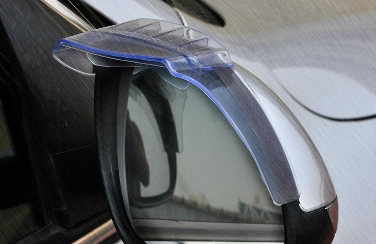 Transparent rain guard attached to a car side mirror, flexible fit over the edge