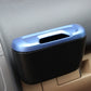 Blue and black car mini storage bin on vehicle console near vents