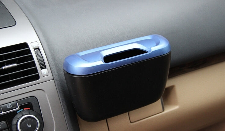 Blue and black car mini storage bin on vehicle console near vents