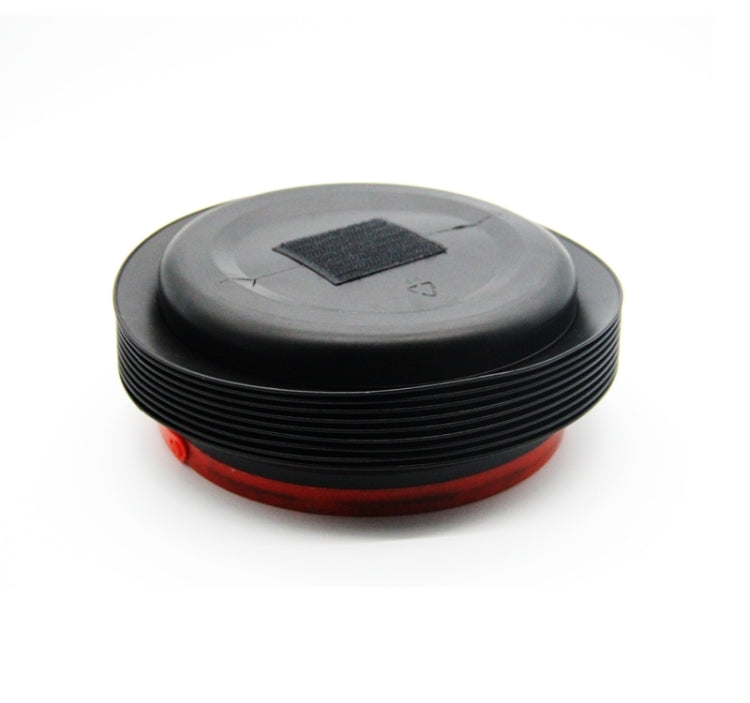 Black folded car container with gray top disk, red base ring, round shape
