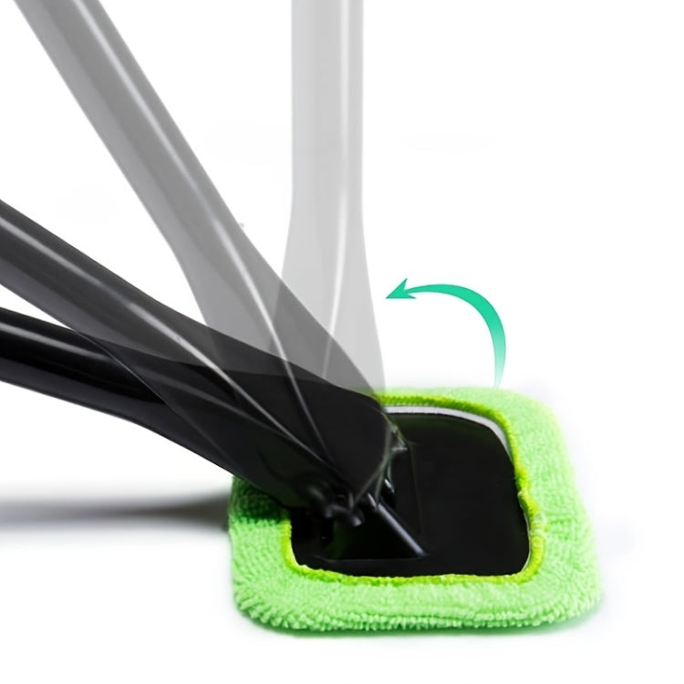 Green microfiber windshield cleaning pad with tool wiping black glass