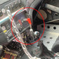 Installed car battery master switch with chrome knob and red lever inside dashboard