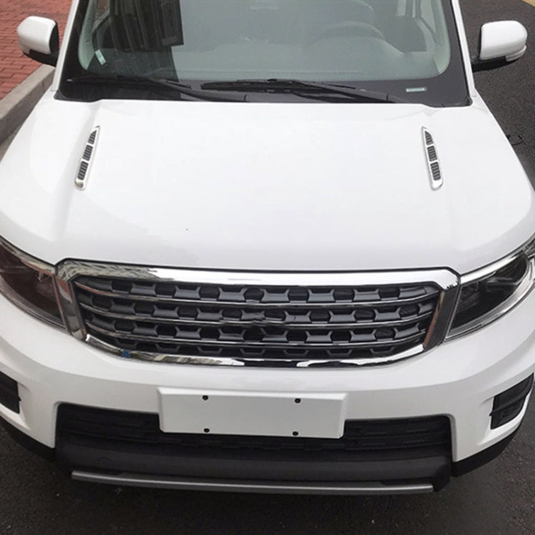 Installed car hood air vent grille decals on a white vehicle, chrome and black