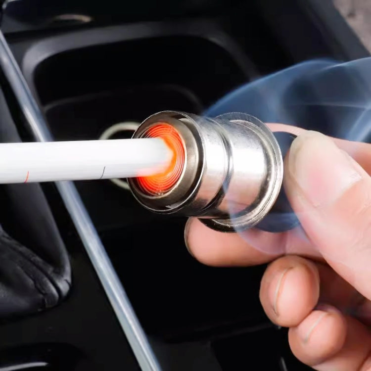 Hand inserting cigarette lighter plug into car socket with glowing heating tip