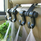 Black double hook bag hanger attached to car seat headrest for hanging items