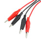 Close-up of red and black test lead probes with metal tips on insulated leads