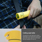 Yellow emergency flashlight with seat-belt cutting head, held in a hand