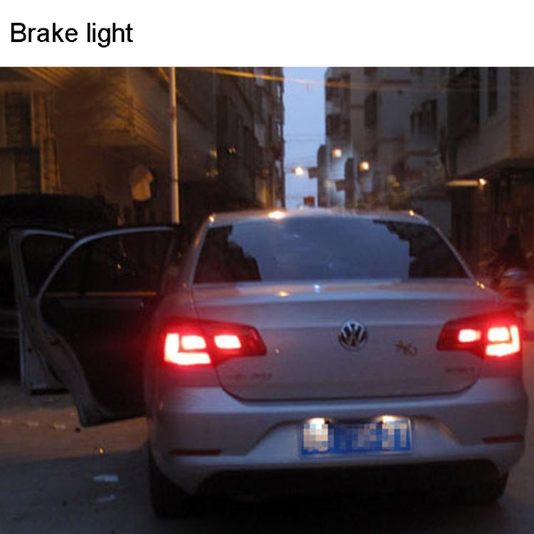 Vehicle rear showing illuminated red brake light