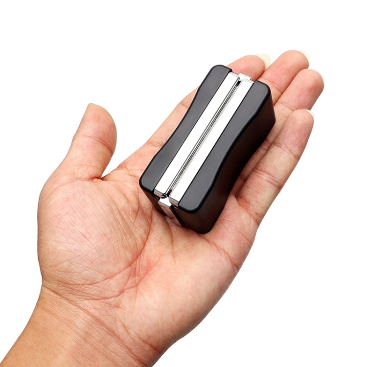 Wiper blade restorer tool held in hand, black body with chrome rails