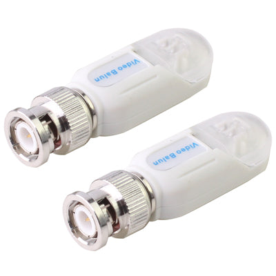 Two white video baluns with threaded BNC male connectors, close-up