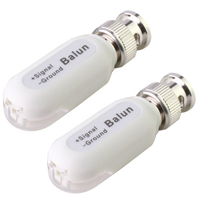 Two white video baluns with BNC male ends, labeled signal and ground
