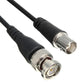 Close-up of coax connectors on a black cable pair with metal BNC-style ends