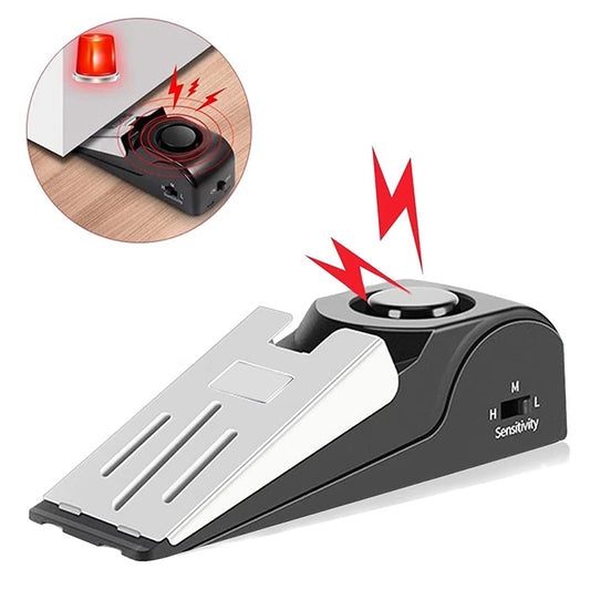 Black wedge door stop alarm with circular button and silver contact plate