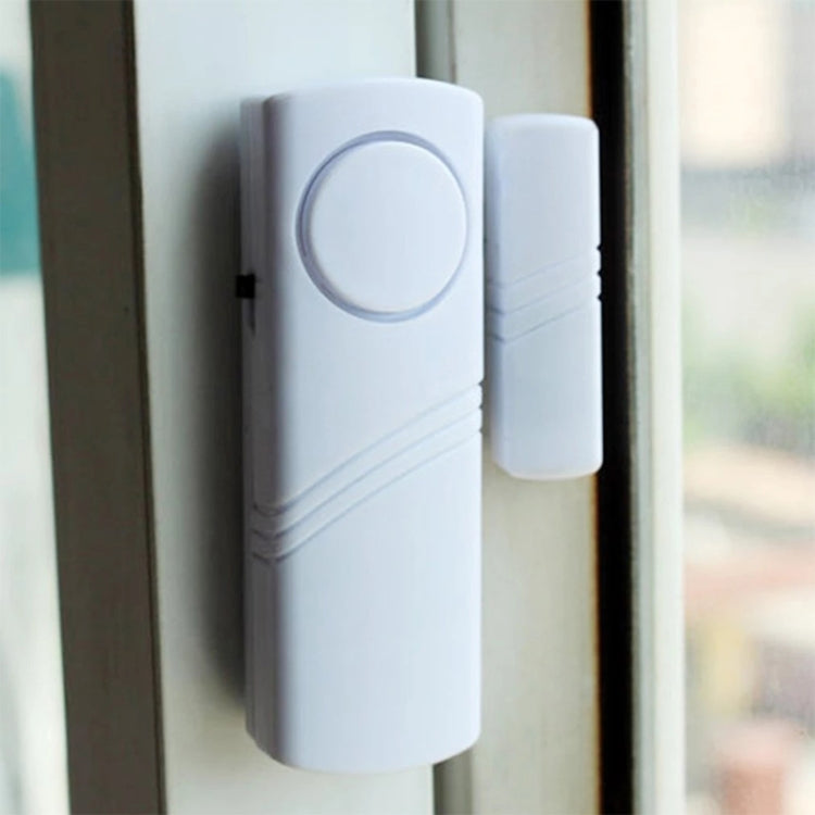 Wireless door/window alarm mounted on a door frame with magnetic sensor nearby
