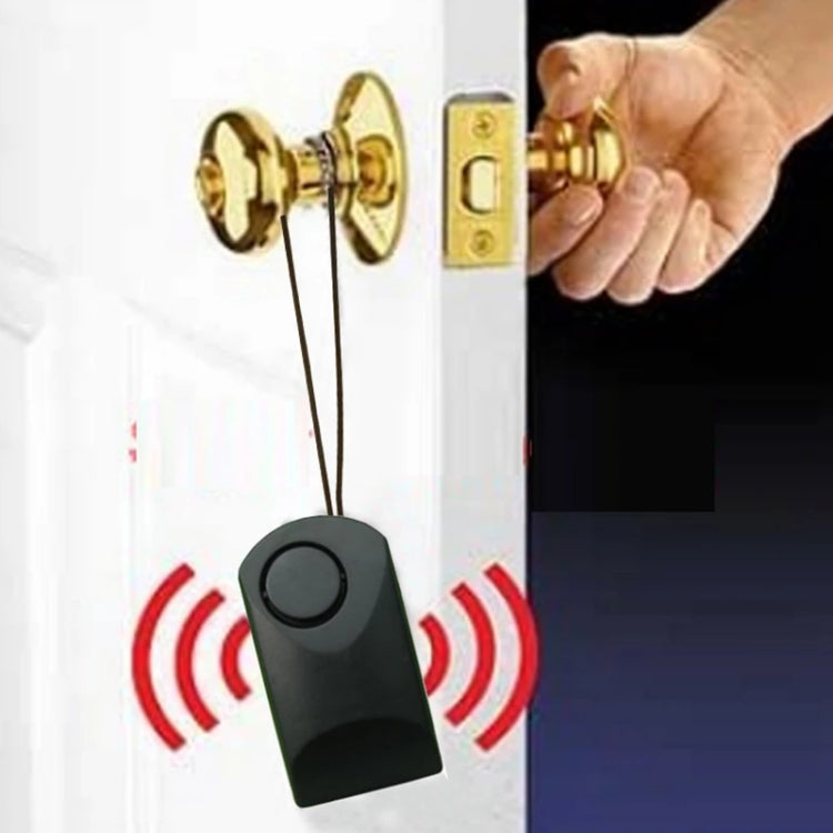 Black anti-theft alarm key fob clipped near a door lock with red alarm signal