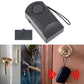 Black anti-theft alarm key fob with round button, charger plug and lanyard
