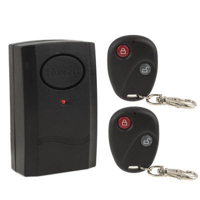 Black vibration alarm with round control button and LED indicator; includes 2 remote keyfobs