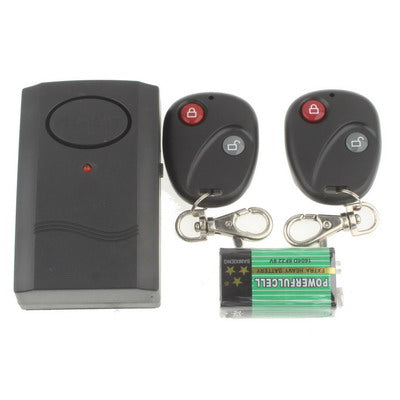 Black alarm unit with two black remote keyfobs and spare AA batteries included