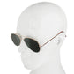 Rose-gold sunglasses with dark oval lenses on a mannequin head