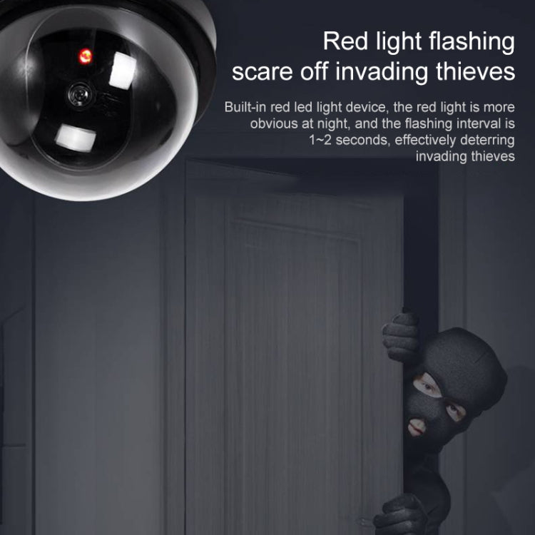 Dummy dome security camera close-up showing flashing red light LED