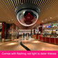 Dummy dome security camera installed on ceiling inside a shopping mall corridor