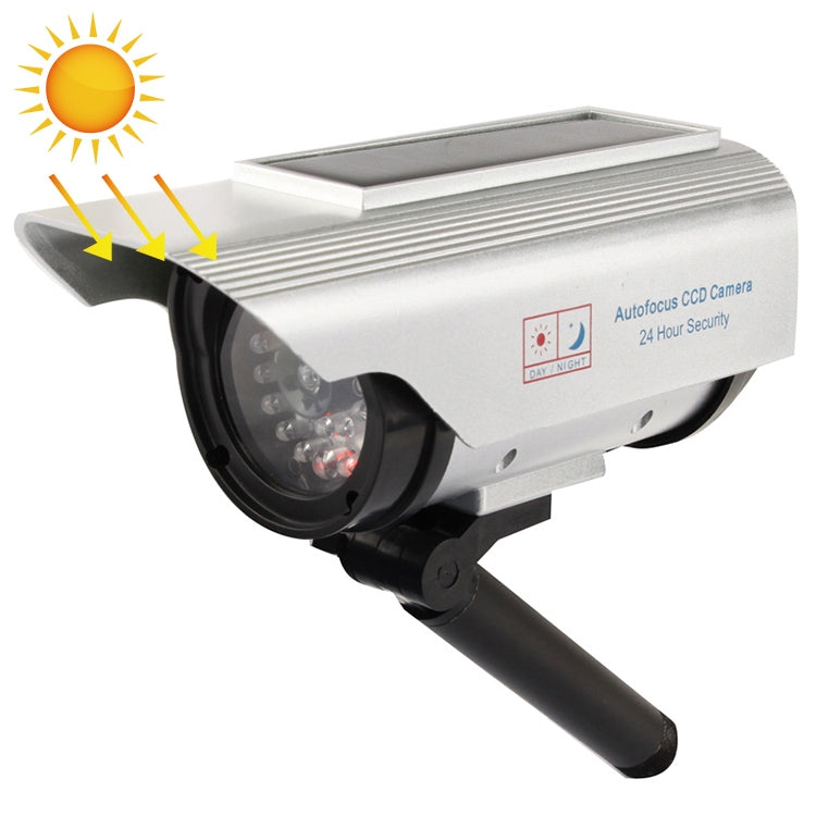 Solar-powered dummy security camera with black mounting arm and front lens window
