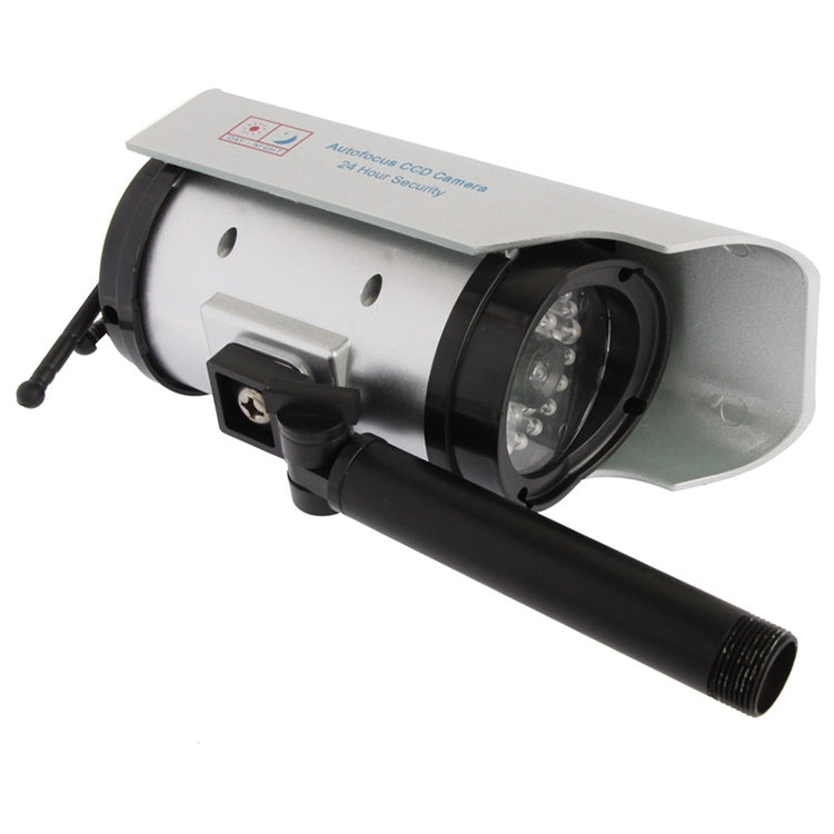 Solar-powered dummy security camera side view with wide lens and black mounting base