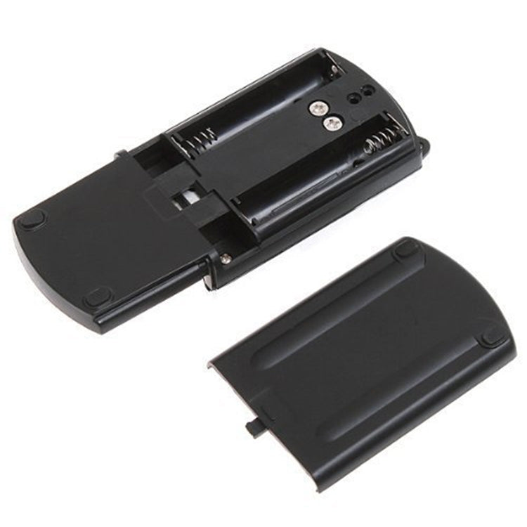 Mini digital scale with battery compartment open, showing internal slots and contacts