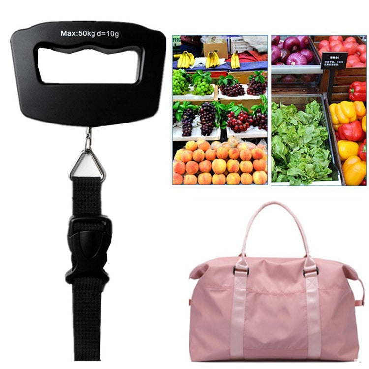Black electronic luggage scale with strap attached to pink duffel bag
