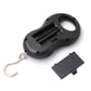 Black LCD hanging scale back view with open battery compartment and metal hook