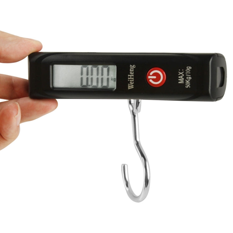 Black portable electronic luggage scale held by hand, with digital LCD display and hook