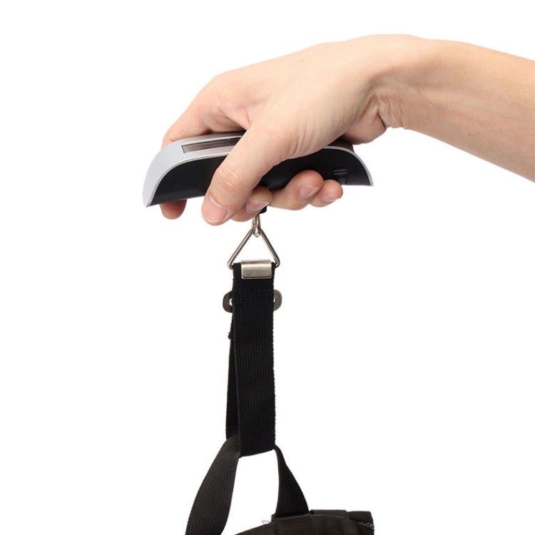 Mini handheld luggage scale in use, hand holding silver housing with LCD and hook