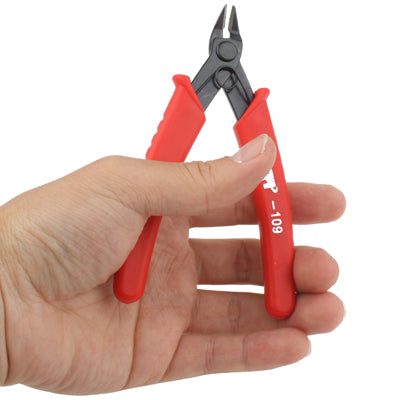 Mini cutter held in hand, red insulated handles and black jaws, -109 marking