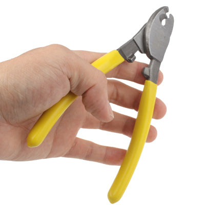 Wire stripper pliers with yellow insulated handles held by a hand