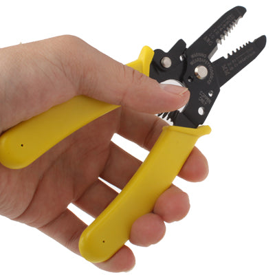 Hand using yellow-handled wire stripper cutter pliers with black serrated jaws.