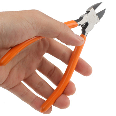 Mini diagonal cutting pliers held in hand; orange handles with silver jaws