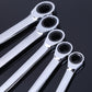 Close-up of chrome ratchet wrenches with black socket openings, set of 5
