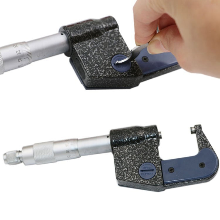 Digital micrometer held near workpiece, showing blue base and silver measuring rod
