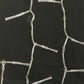 Clear-wire LED string lights close-up with small white bulb housings