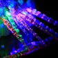 Lit multi-colored LED string lights with clear bulbs on diagonal wire strands