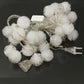 30-LED multi-colored string lights with white pom-pom bulbs and EU plug power adapter.