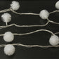 30-LED multi-colored string lights with spaced white pom-pom bulbs along the wire strand.