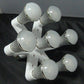 Seven-way E27 lamp holder converter holding multiple bulbs, white body with threaded bases