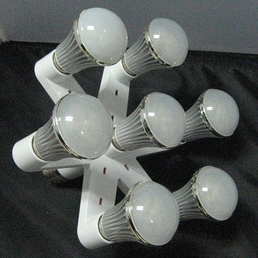 Seven-way E27 lamp holder converter holding multiple bulbs, white body with threaded bases