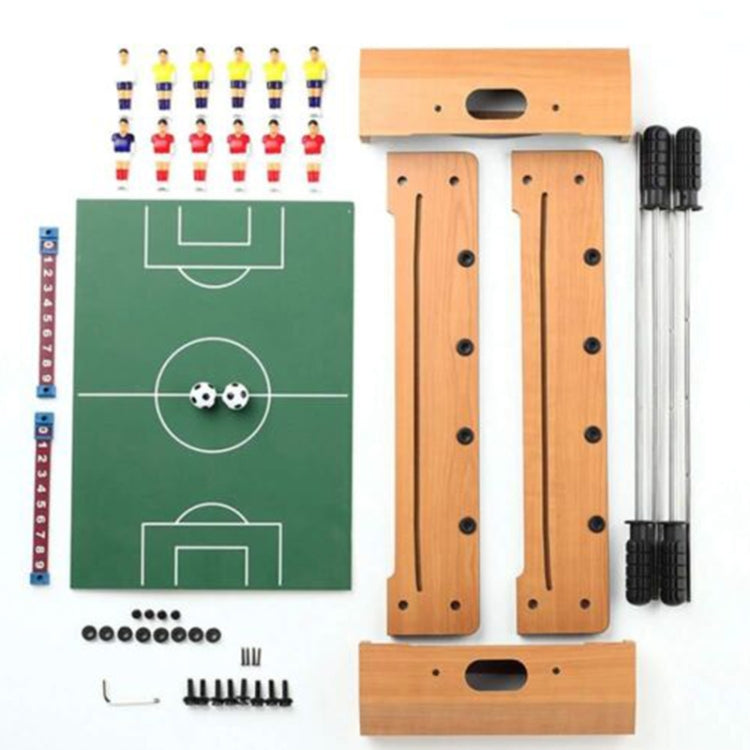 Tabletop football game set pieces with green pitch, rods, and mini player figures