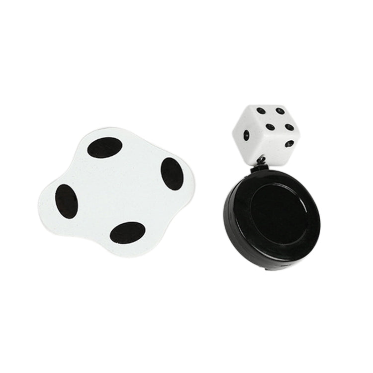 Flat magic trick toy with white dice and round black base