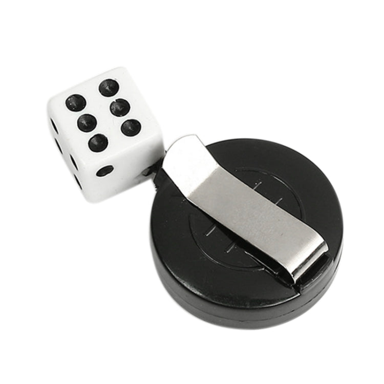 White dice and black circular magic base with metal tab, close-up