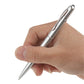 Silver pen with pointed tip, held between fingers; metallic cap at top