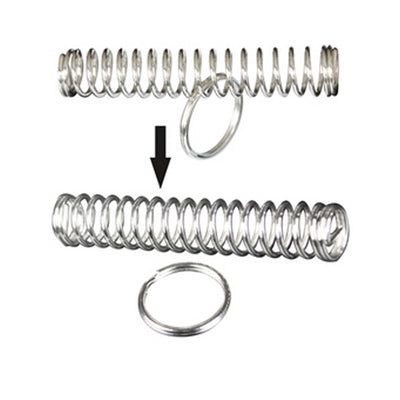 Metal ring and coiled spring trick toy, with two springs and a loose ring